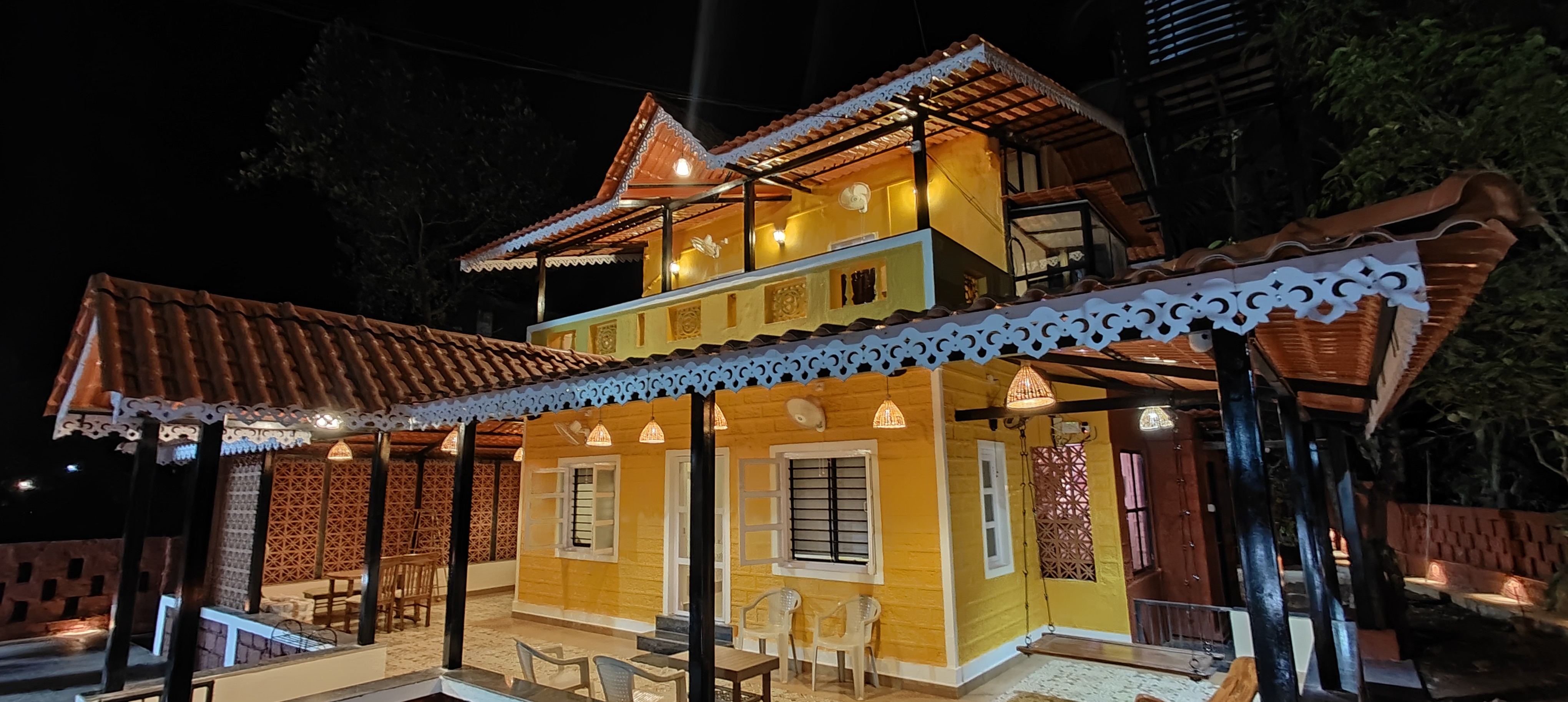 Saraswati Vinayak Villa lit up at night in Dapoli