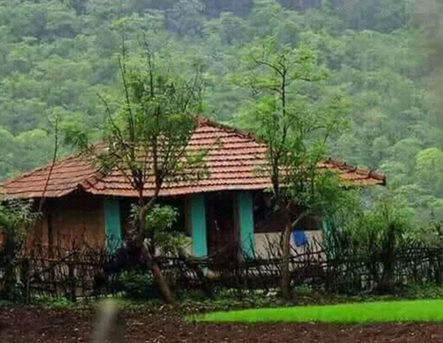 Traditional tiled-roof cottage in the green Panchanadi valley