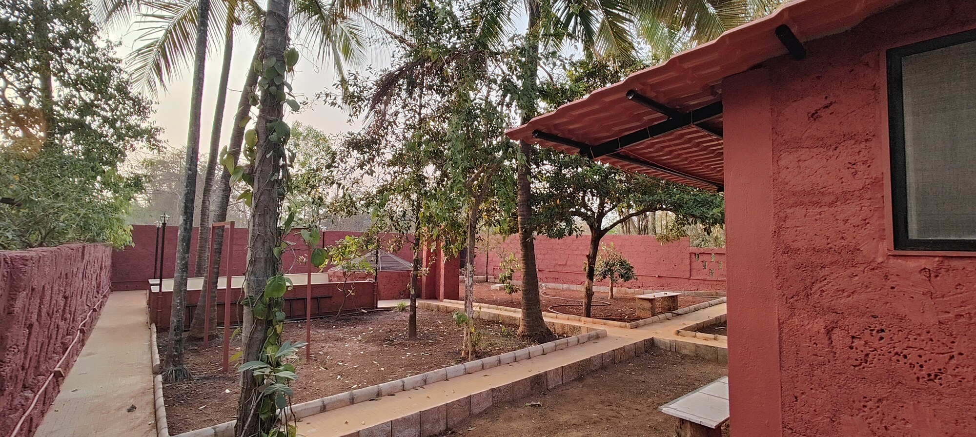 Shaded garden pathway beside the villa