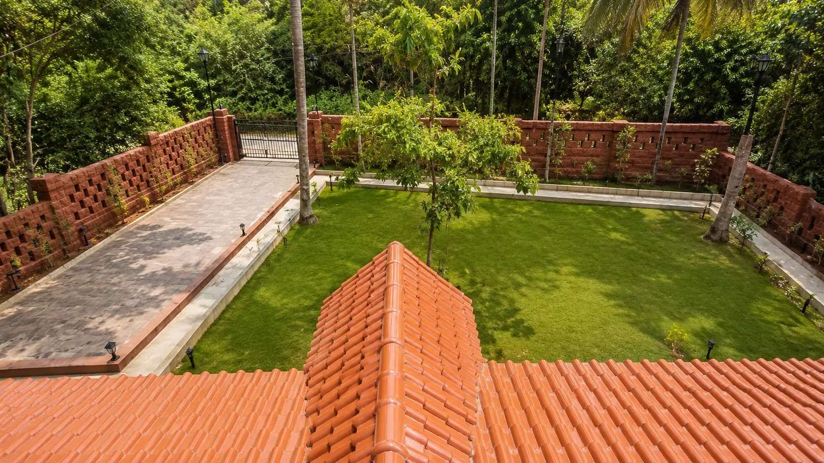 Aerial view over the villa roof to the lawn and driveway