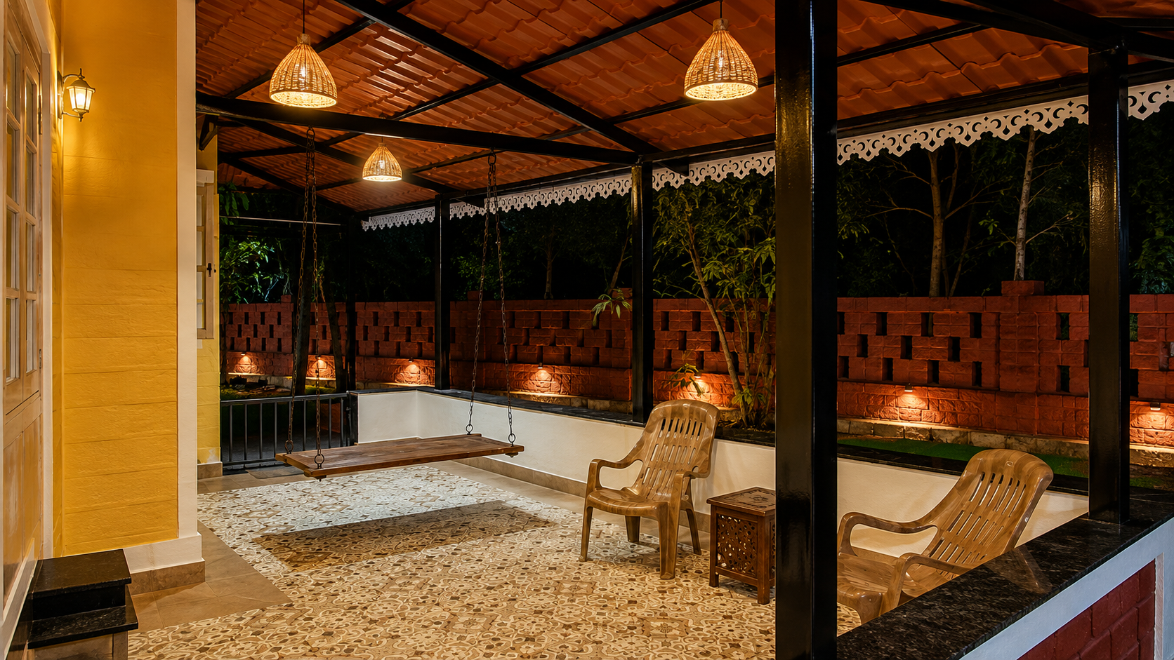 Verandah at night with hanging lamps, wooden swing and jaali brick wall