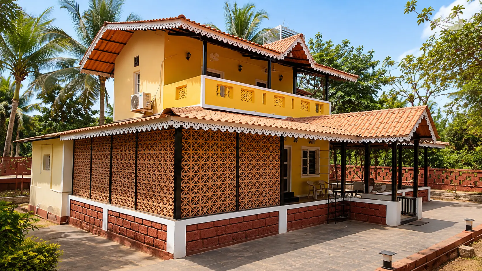 Daytime view of the villa with jaali walls and tiled roof