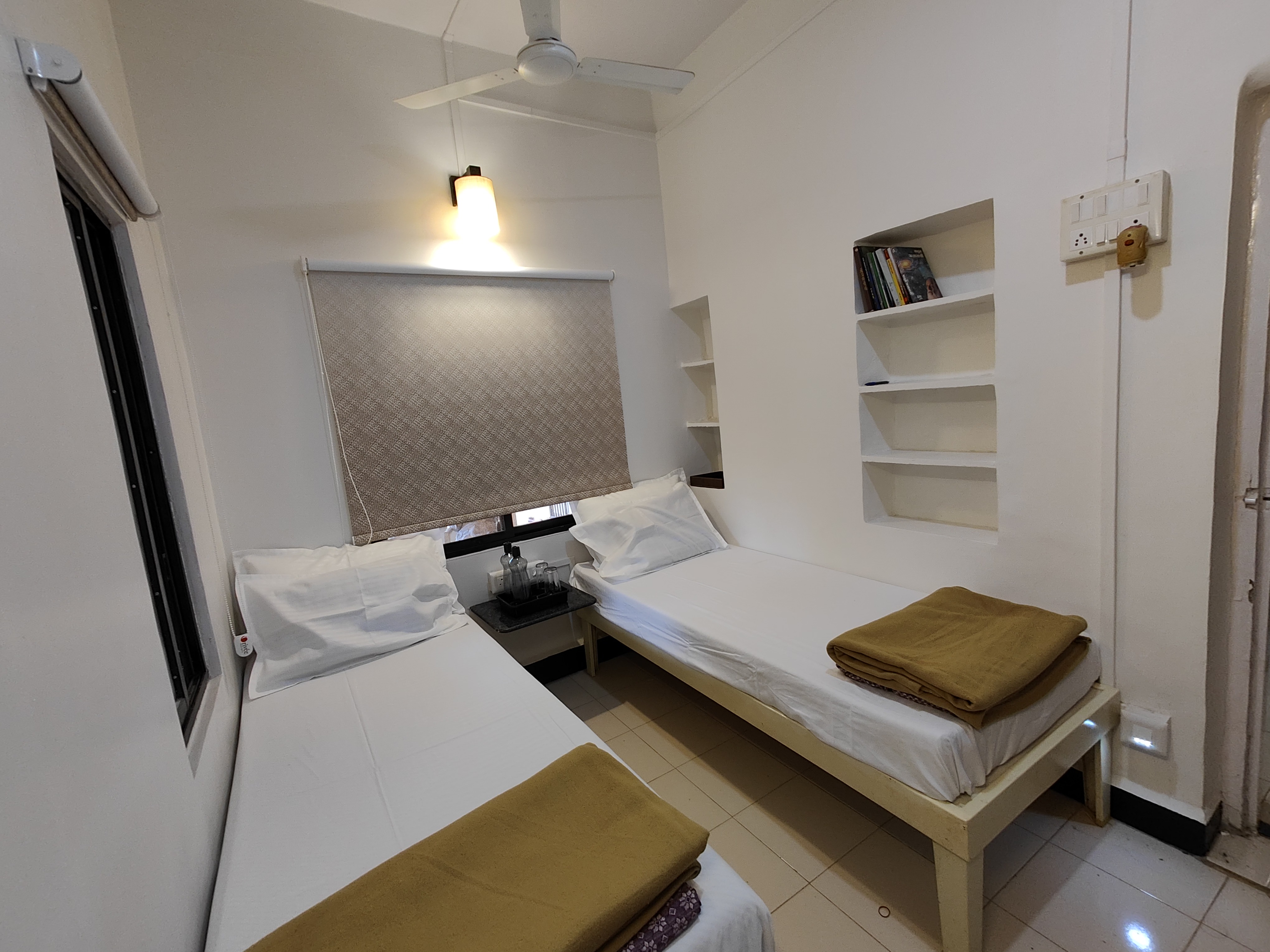 Second bedroom with two single beds and warm lighting at the villa